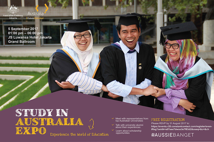 Three graduated students holding hands together